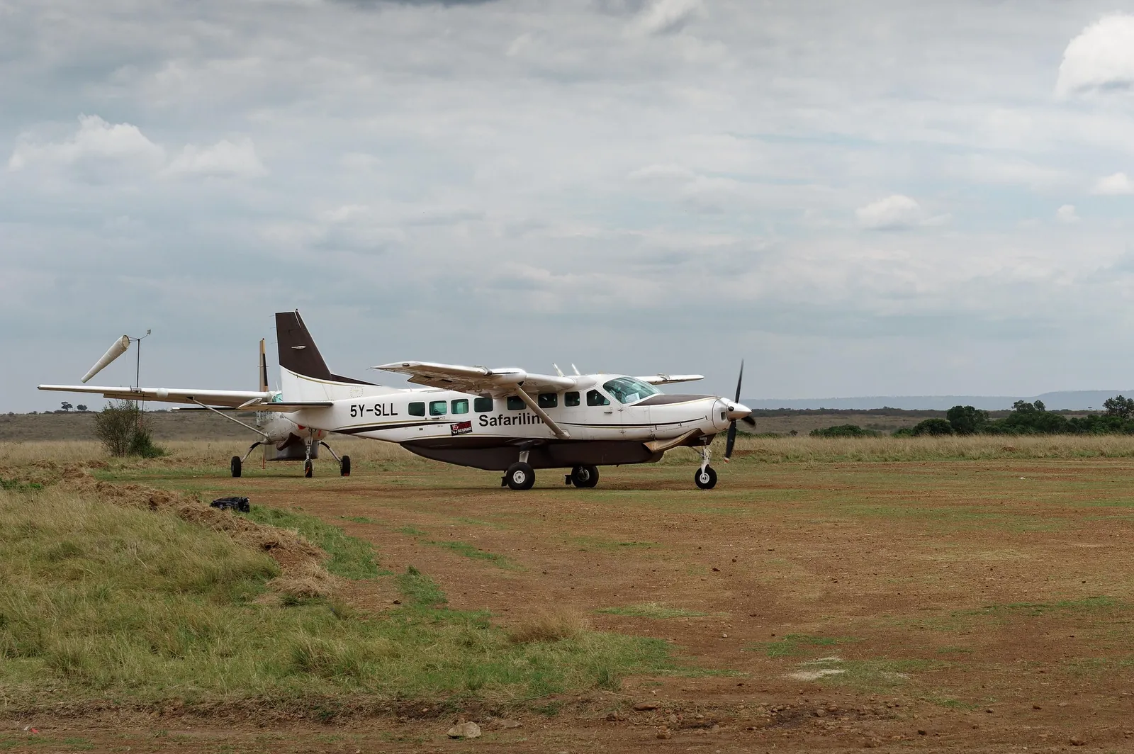 A light aircraft on a bush airstrip, used for safari transfers in East Africa